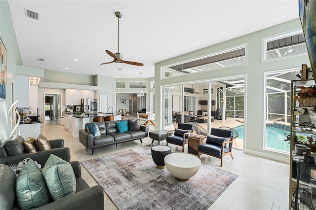 tiled living room featuring ceiling fan