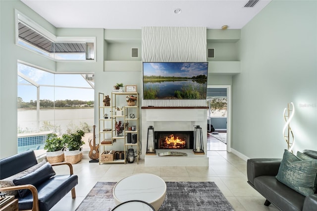 living room featuring light tile patterned floors and a towering ceiling