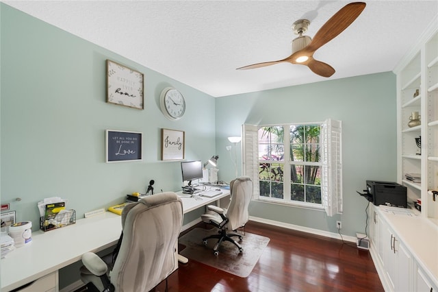 office space featuring ceiling fan, dark wood-type flooring, and a textured ceiling