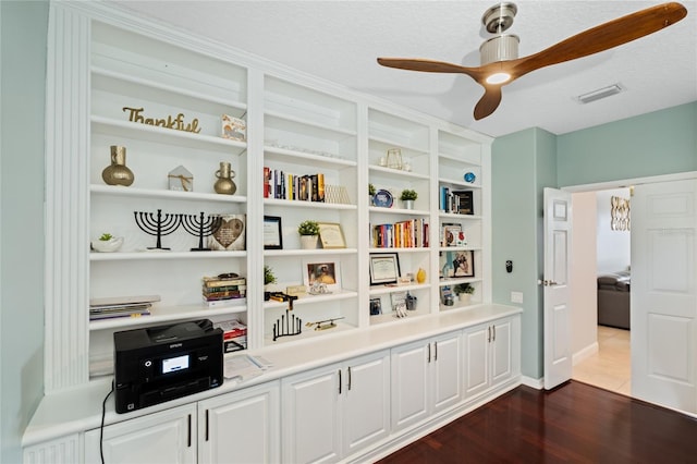 interior space featuring hardwood / wood-style flooring, ceiling fan, and a textured ceiling