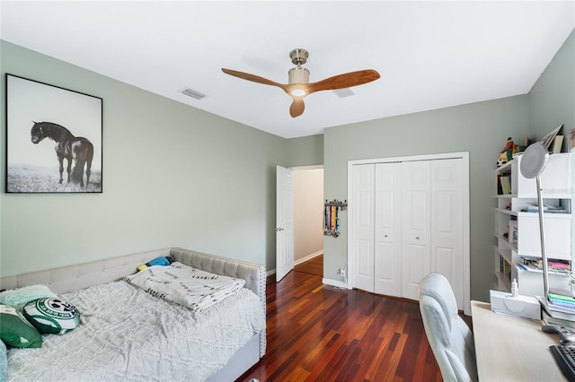 bedroom featuring ceiling fan, a closet, and dark hardwood / wood-style flooring