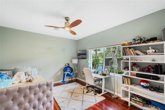 office area featuring ceiling fan and dark wood-type flooring