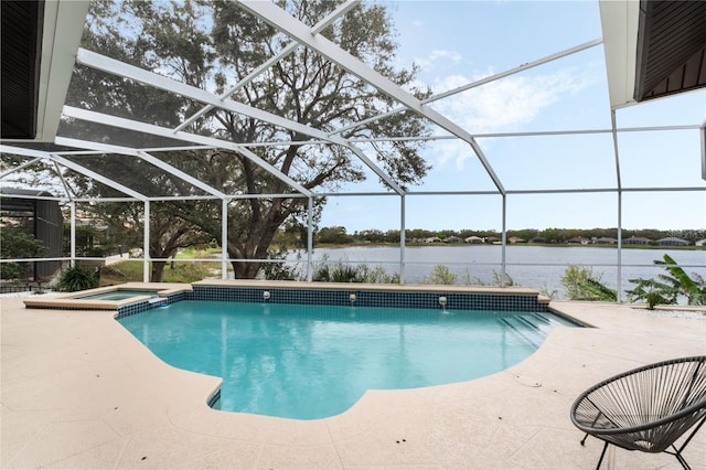 view of pool featuring a patio area, a water view, an in ground hot tub, and glass enclosure