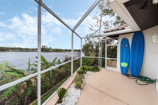 unfurnished sunroom featuring a water view