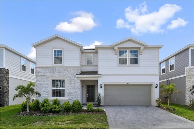 view of front of home featuring a garage and a front lawn