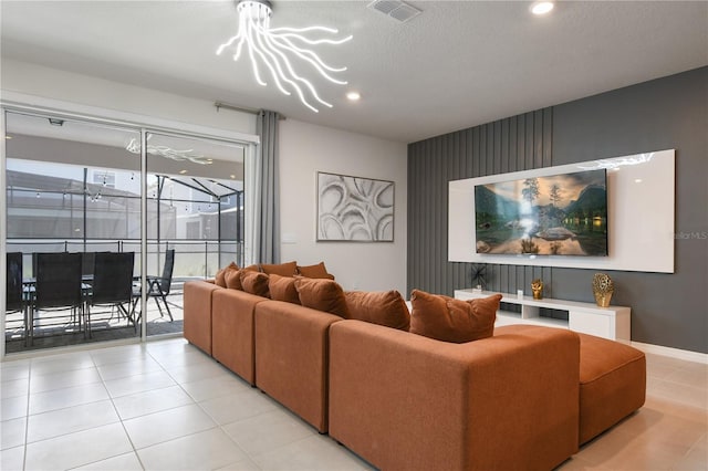 living room with a textured ceiling and light tile patterned flooring