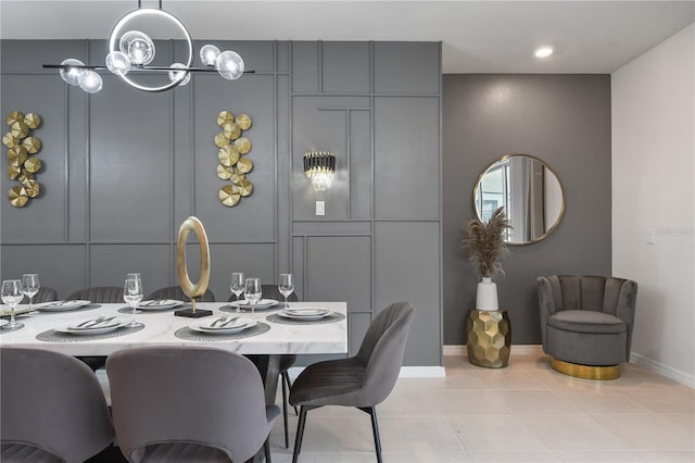 dining area with light tile patterned floors and a chandelier