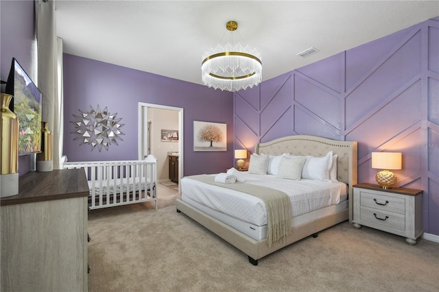 bedroom with light colored carpet and a chandelier