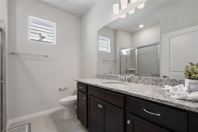 bathroom with vanity, toilet, and a shower with shower door