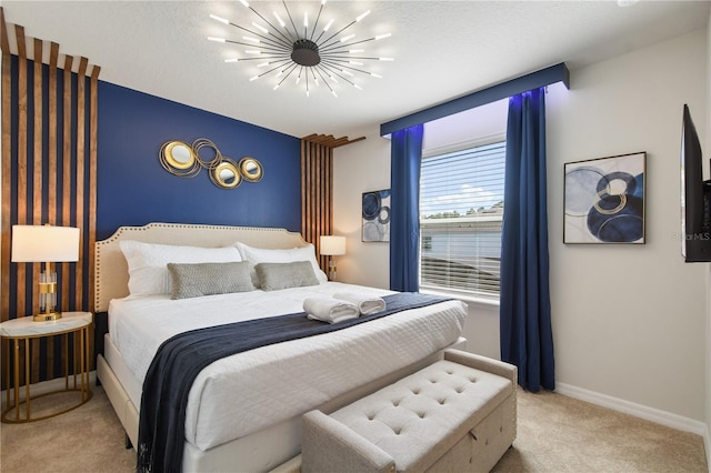 carpeted bedroom featuring a textured ceiling and an inviting chandelier