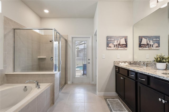 bathroom with tile patterned flooring, vanity, and independent shower and bath