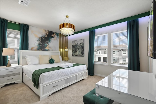 bedroom featuring light carpet and an inviting chandelier