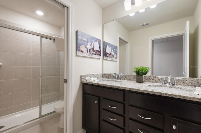 bathroom with vanity, an enclosed shower, tile patterned floors, and toilet