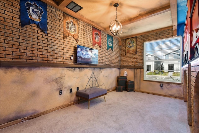 interior space with brick wall, a chandelier, and carpet