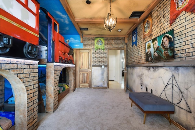 miscellaneous room with beamed ceiling, brick wall, and light carpet