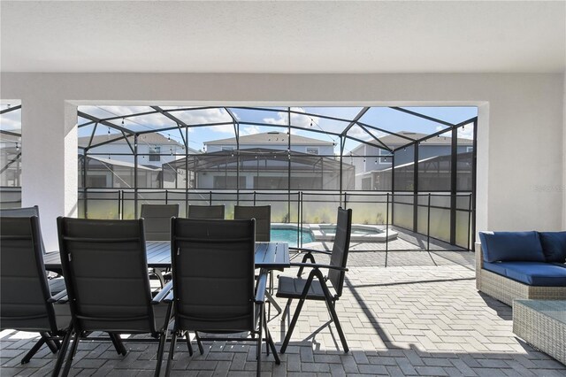 view of patio featuring glass enclosure