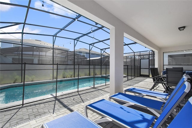 view of pool with a lanai and a patio area