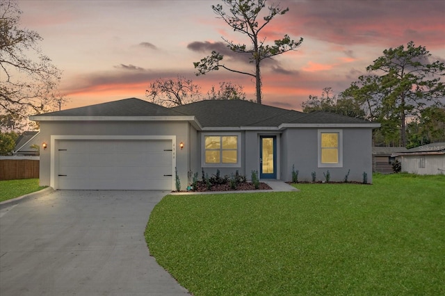 view of front of property featuring a yard and a garage