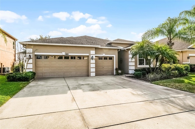 view of front of house featuring a garage and central AC