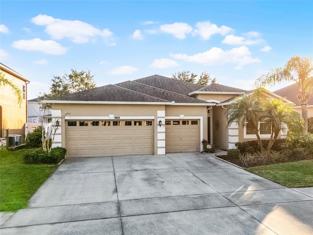 view of front of home featuring cooling unit and a garage