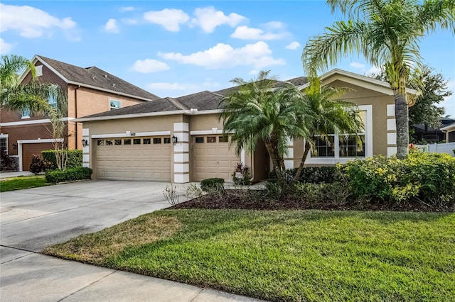 view of front of house featuring a garage and a front lawn