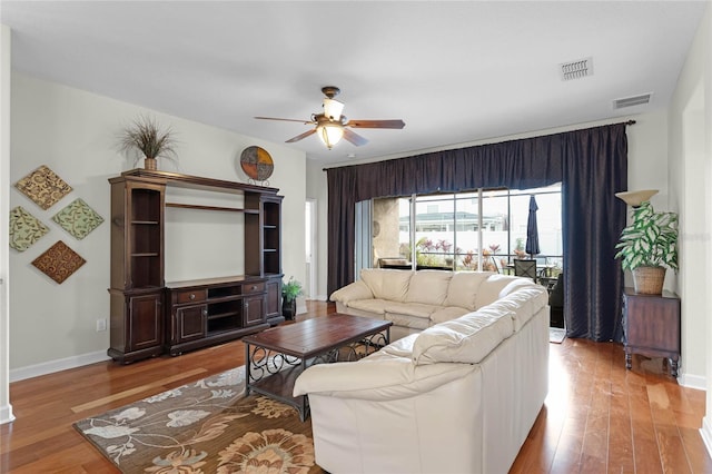 living room with hardwood / wood-style floors and ceiling fan