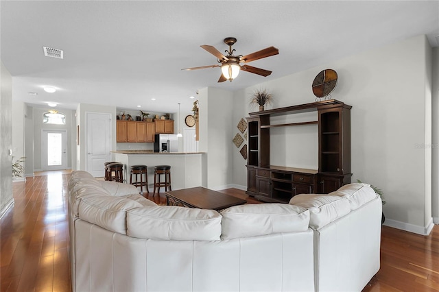 living room featuring hardwood / wood-style floors and ceiling fan