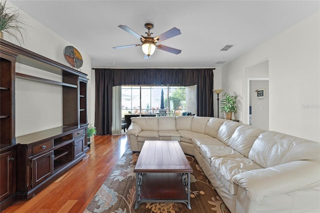 living room with ceiling fan and hardwood / wood-style floors