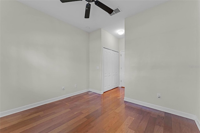 empty room with hardwood / wood-style flooring and ceiling fan