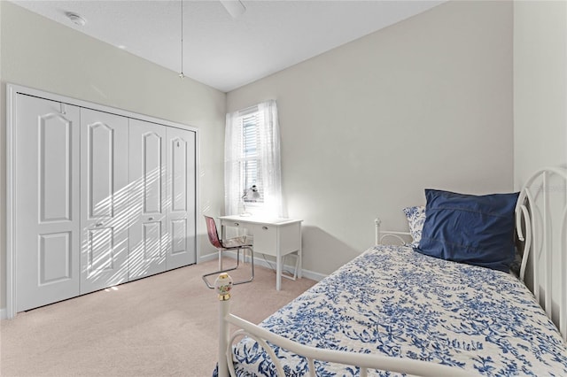 carpeted bedroom featuring a closet and ceiling fan