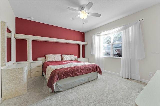 bedroom with light carpet, ceiling fan, and a textured ceiling