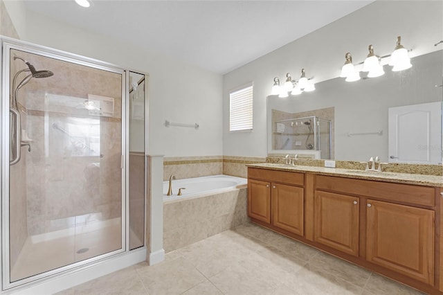 bathroom featuring shower with separate bathtub, vanity, and tile patterned floors