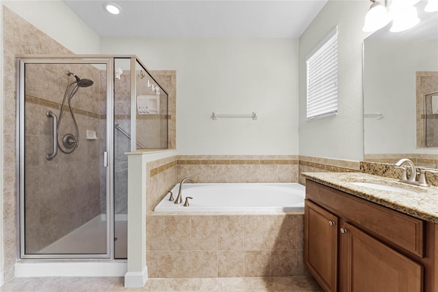 bathroom featuring vanity, tile patterned flooring, and shower with separate bathtub