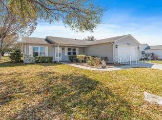 ranch-style house featuring a garage and a front lawn