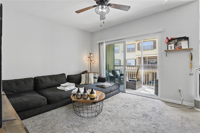 living room featuring ceiling fan and carpet