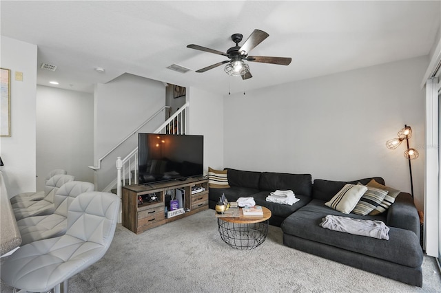 carpeted living room with ceiling fan