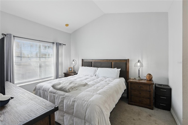 carpeted bedroom featuring lofted ceiling