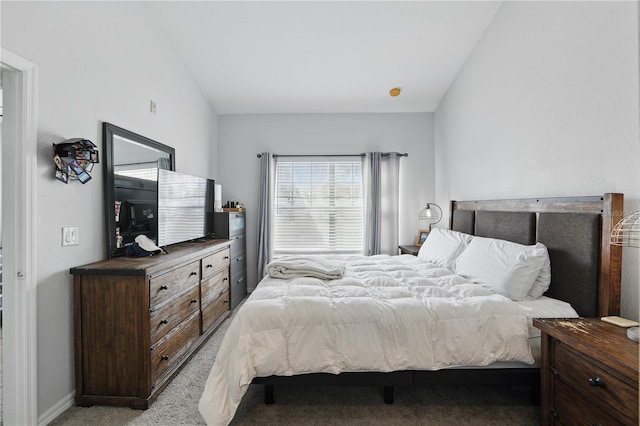 carpeted bedroom with vaulted ceiling