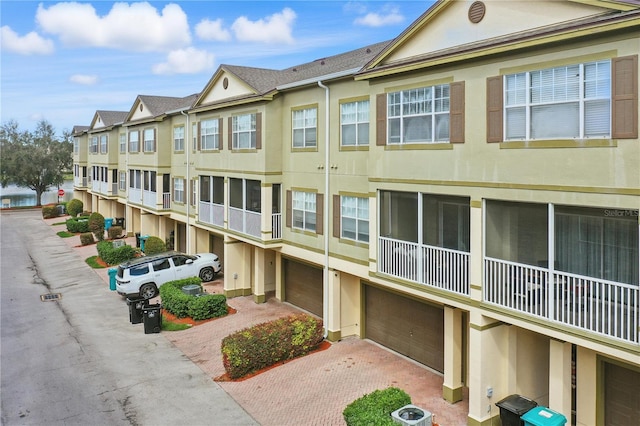 view of property featuring a garage and central air condition unit