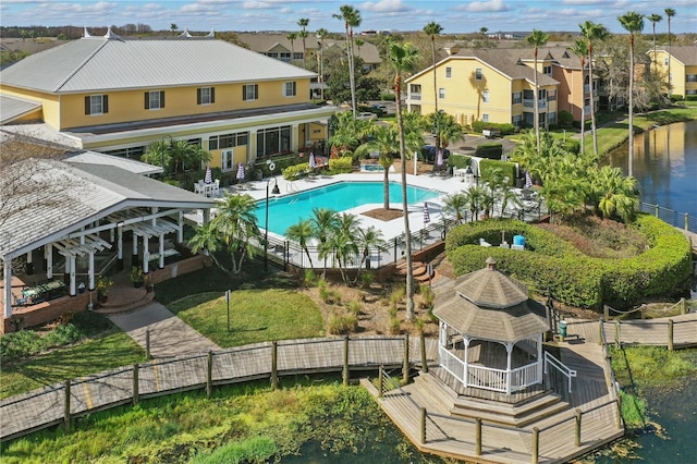 view of swimming pool with a patio and a water view