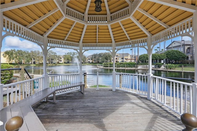 view of dock with a gazebo and a water view