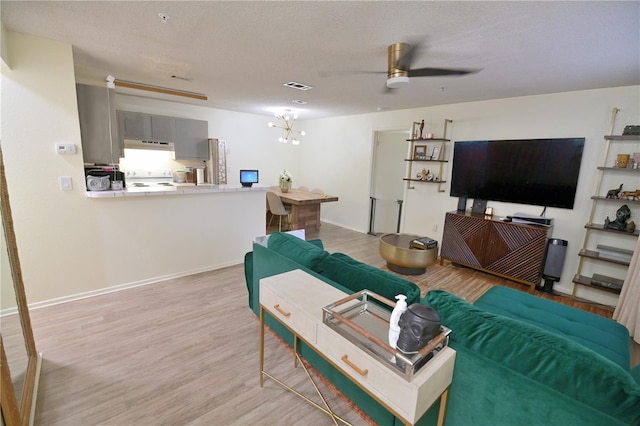974 Leeward Pl Unit 205, Altamonte Springs, FL 32714 - living room featuring ceiling fan, light wood-type flooring, a chandelier, a textured ceiling, and baseboards