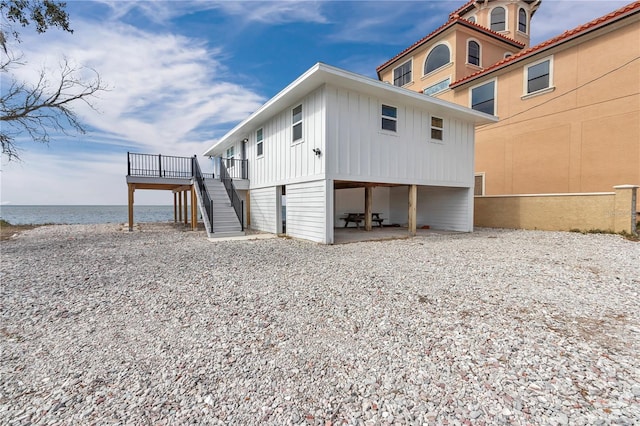 exterior space with a deck with water view