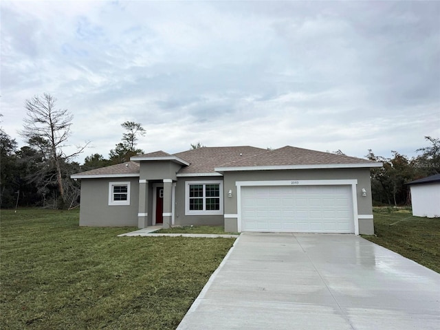 view of front of property featuring a garage, stucco siding, and a front yard