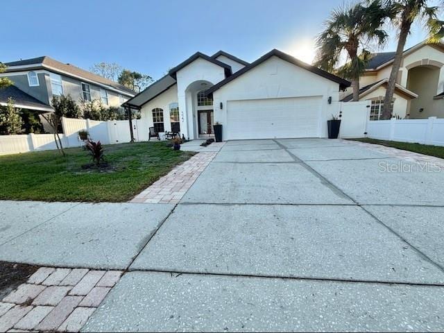 view of front of house featuring a garage and a front yard