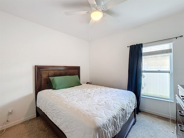 bedroom featuring ceiling fan and carpet