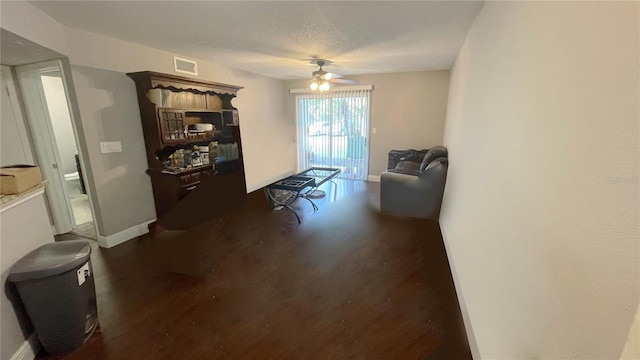 interior space featuring ceiling fan and a textured ceiling