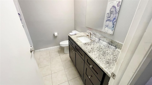 bathroom featuring vanity, tile patterned floors, and toilet