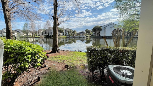 exterior space with central air condition unit and a water view