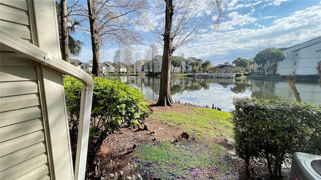 view of yard featuring a water view and cooling unit